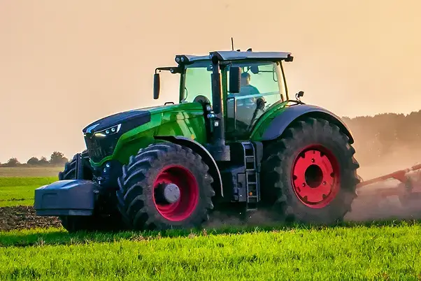 Green tractor resting in a field